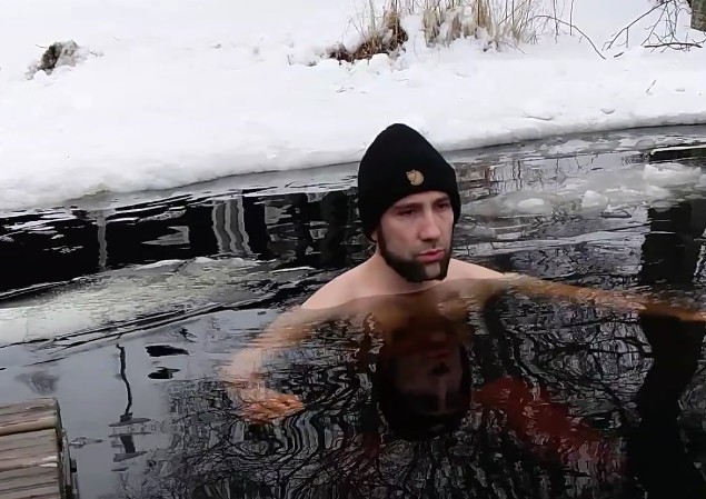 Marius Helf swimming in a frozen lake in Sweden